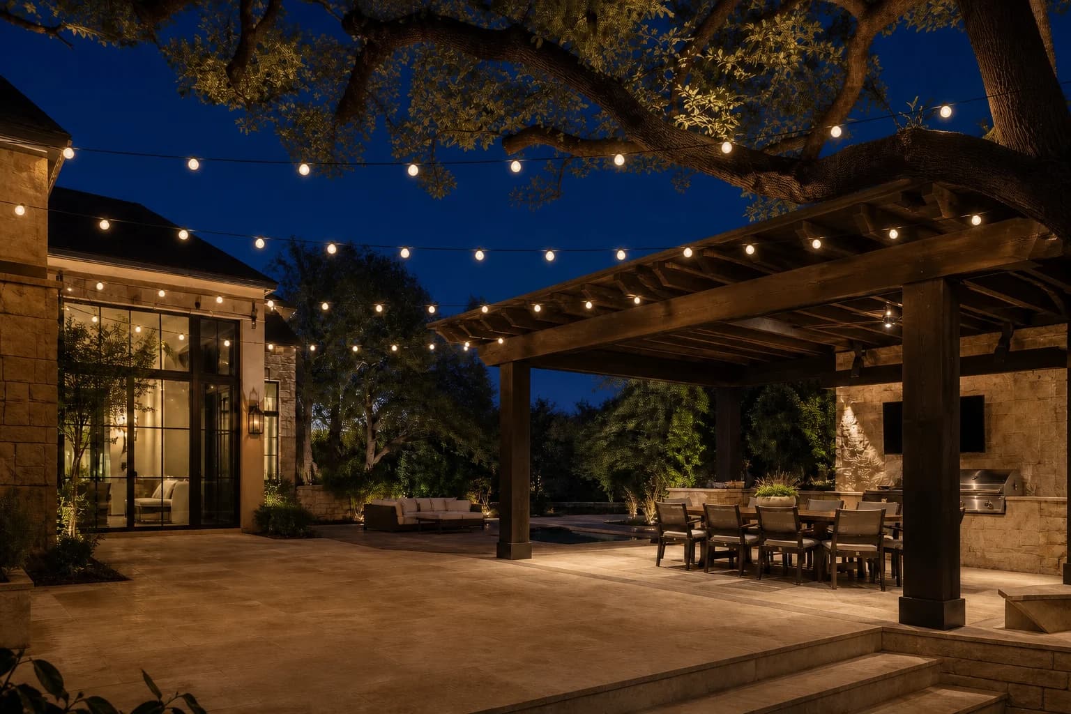 Compact warm-white globe string lights installed over the patio and pergola of a fictional example home
