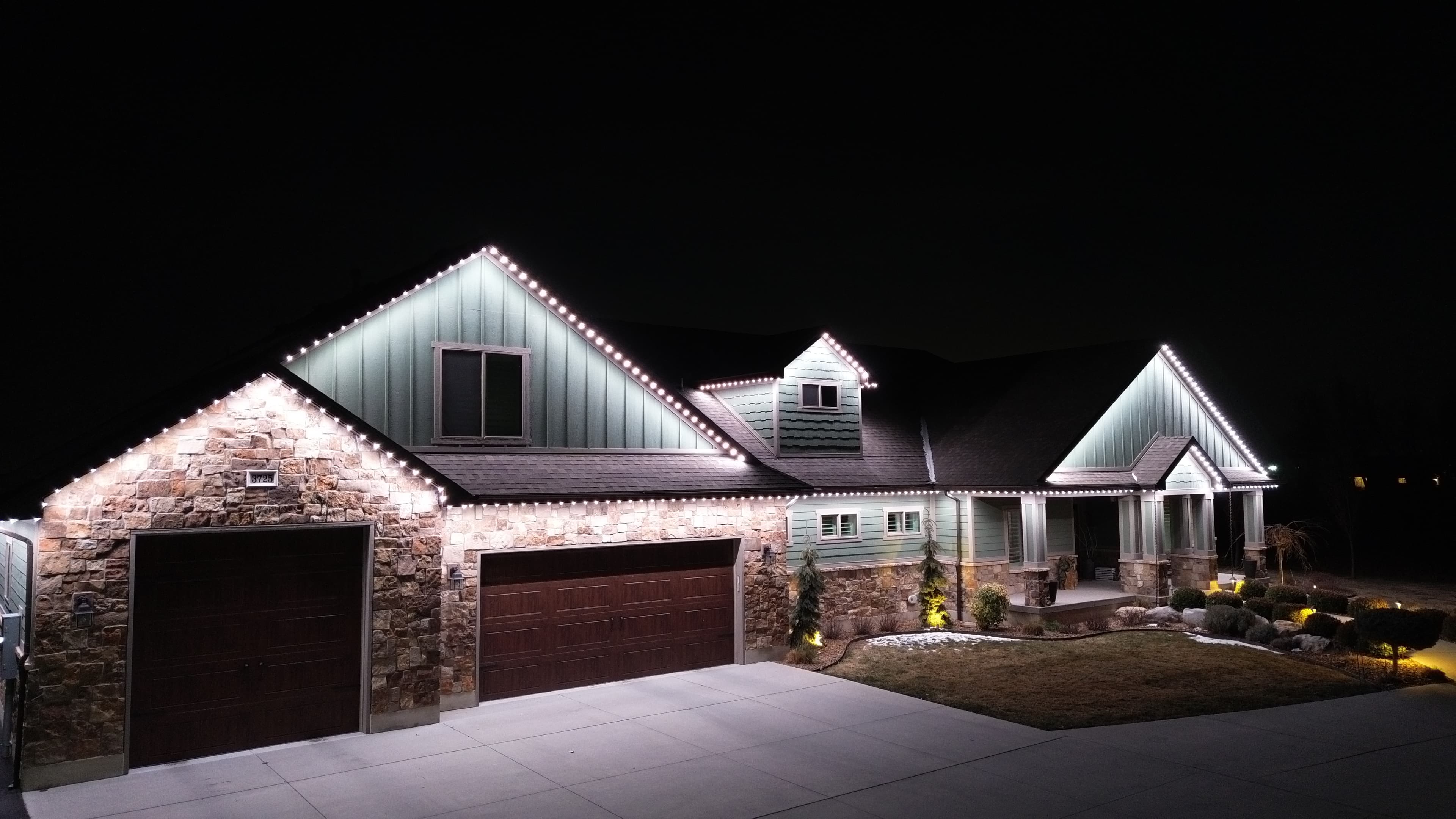 Security lighting illuminating a home at night (TruLight network install)